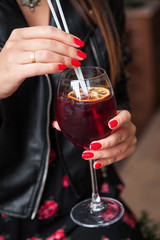Woman drinking wine, sangria in outdoor cafe