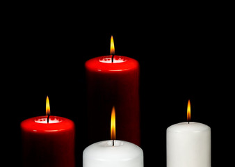 red candle on a black background.christmas candle background