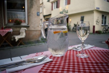 table in a restaurant, with water pitcher, wineglass, silverware