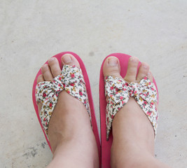 woman feet wear pink slippers