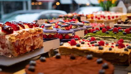 Cake shop with sweets on showcase table, close-up.