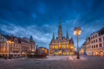 Fototapeta na wymiar Liberec, Czechia. View of main square with Town Hall building and fountain at dusk (HDR-image)