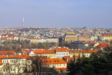 Obraz premium Panoramic view of Old Town in Prague in a beautiful summer day. Top view to colorful roofs skyline of capital city Prague, Czech republic. 