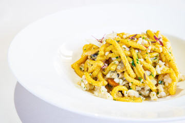 Homemade passatelli, a traditional Italian recipe. Pasta with fish sauce. Italian cuisine. White...