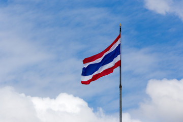 Image of waving Thai flag of Thailand with blue sky background.