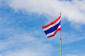 Image of waving Thai flag of Thailand with blue sky background.