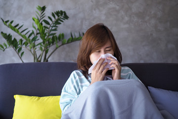Asian women have high fever and runny nose. sick people concept