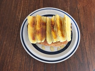 Fresh homemade toast with grilled banana topping - horizontal cutting. Delicious breakfast. 