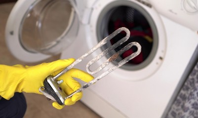 Treatment of Calcium Deposits in Water Heater. Limescale on the heating element for washing machine.  Replacing a heating element