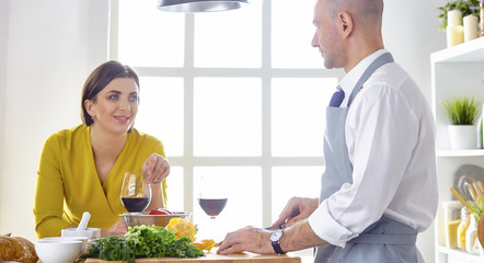 Smiling young couple cooking food in the kitchen