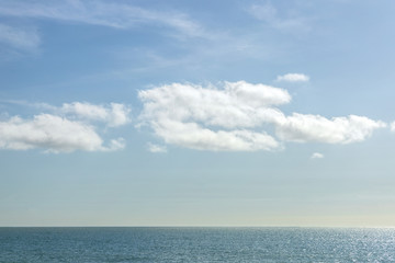 Fototapeta na wymiar Blue sea and blue sky with white clouds, sunny day in United Kingdom