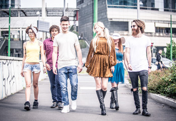 Naklejka premium Group of teenagers walking in the city center