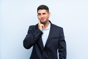 Handsome man over isolated blue background Looking front