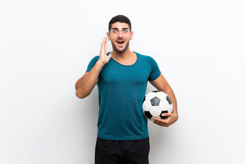 Handsome young football player man over isolated white wall with surprise and shocked facial expression