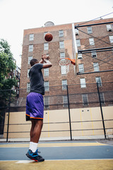 Fototapeta na wymiar Basketball player training on a court in New york city