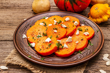 Roasted pumpkin with salted cheese and herbs