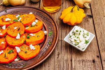 Roasted pumpkin with salted cheese and herbs