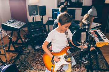 kids rock band playing in music studio