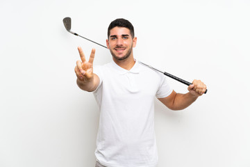 Handsome young golfer player man over isolated white background smiling and showing victory sign