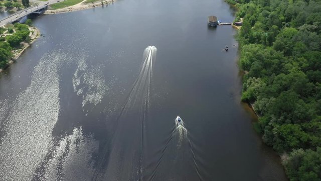 Jet-ski moving fast on blue river surface. Aerial top view of riding on a watercraft. 4K video.