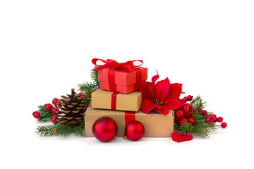 Christmas decoration. Gift boxes with red ribbon, flower of red poinsettia, balls, twigs christmas tree, red berries on white background with space for text