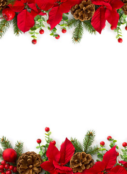 Christmas decoration. Frame of flowers of red poinsettia, branch christmas tree, ball, red berry on a white background with space for text. Top view, flat lay
