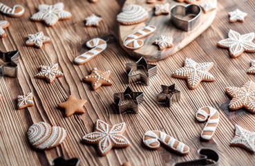 Set of homemade gingerbread on brown wooden background. Christmas cookies in stars shape.