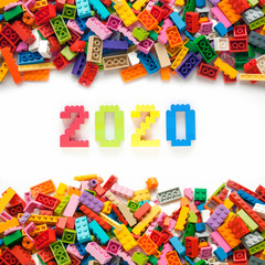 Fototapeta na wymiar Numbers 2020 made from toys blocks with scattered blocks on white background
