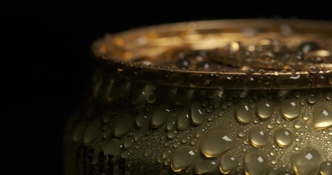 Beautiful frame for advertising alcohol products, macro shot of golden aluminum can, metal covered with large drops of water, fresh drink, sealed packaging, chilled lemonade, alcohol in metal package