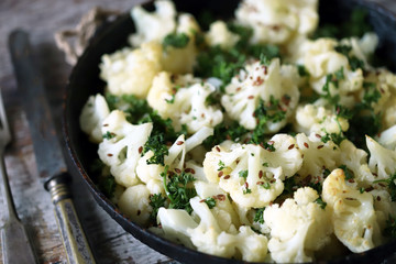 Cauliflower with spices baked in a pan. Vegan food.