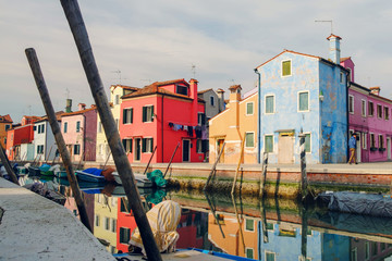 small colored houses reflected on the canal water