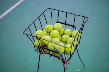 tennis ball in a basket during the day