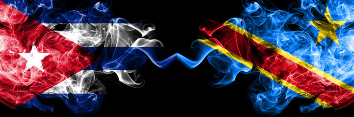 Cuba, Cuban vs Democratic Republic of the Congo smoky mystic flags placed side by side. Thick colored silky travel abstract smokes banners.