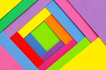 An abstract geometric textured background of multicolored rainbow colors created with overlapping foam craft paper 