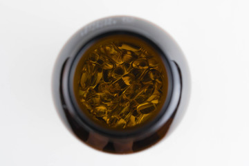 Jar with omega 3 capsules in a cap on a white background