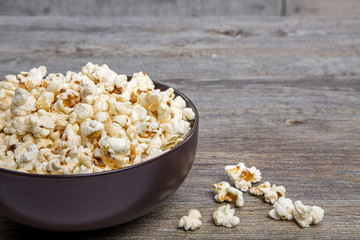 Fresh popcorn in a bowl on a rustic table
