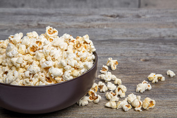 Fresh popcorn in a bowl on a rustic table