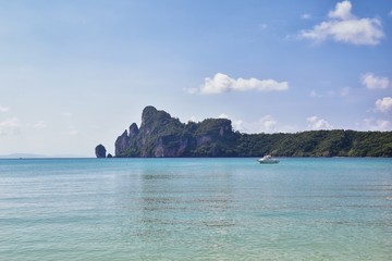 Fototapeta premium Island, Ocean views near Phuket Thailand with Blues, Turquoise and Greens oceans, mountains, boats, caves, trees resort island of phuket Thailand. Including Phi Phi, Ko Rang Yai, Ko Li Pe and other is