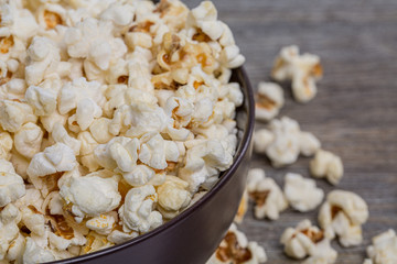 Fresh popcorn in a bowl on a rustic table