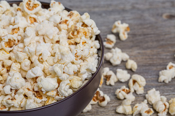 Fresh popcorn in a bowl on a rustic table