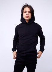 Obraz premium photo of man wearing black hoodie isolated on white background.