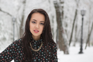 Shot of gothic woman in a winter park.