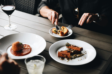 Midsection of man eating rice ball on table