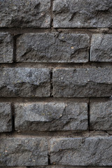 Grey wall covered with rough stone tiles
