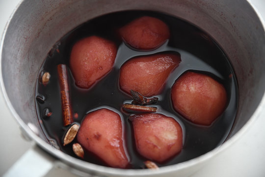 Close up of pears and spices in saucepan