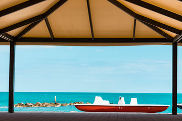 red paddle boat on the beach of  Porto Recanati, Italy