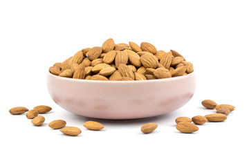 Almonds in pink porcelain bowl on white background