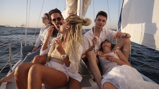 Young people relaxing on a yacht. Party on a yacht. Corporate party on a yacht. Young people having fun on a yacht. Walk on a yacht along the river. Cruise on a boat. Close up