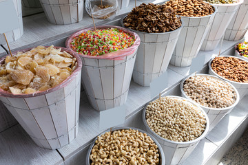 Baskets of delicious, high in calories dry fruits on market shelves.