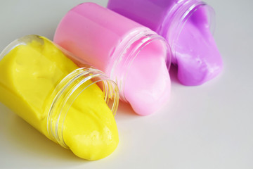 Multicolored slimes in jars spread out on the table.Funny children's toy.